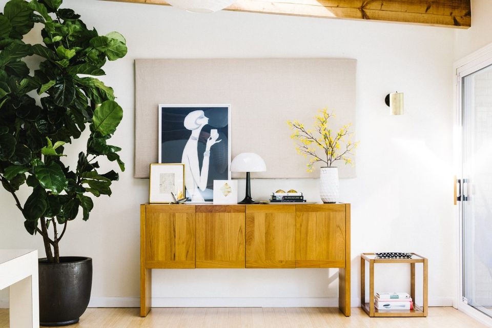 Scandinavian-inspired console vignette with warm wood, greenery, and curated minimalist styling