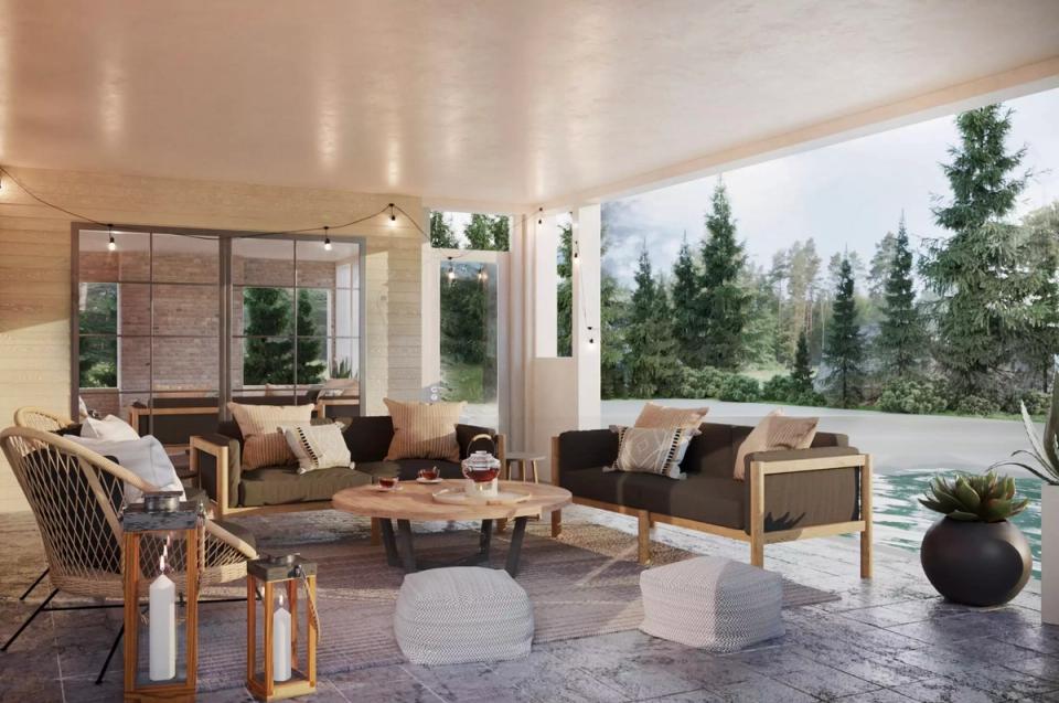 Modern glass-enclosed patio with warm wood tones and forest views