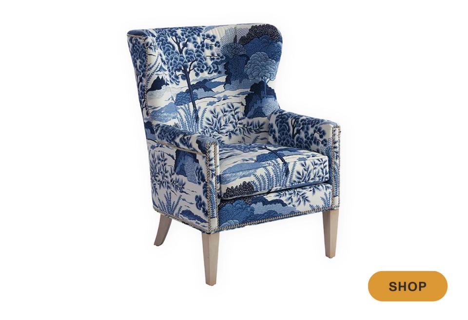 Elegant wingback chair in classic blue and white toile floral pattern