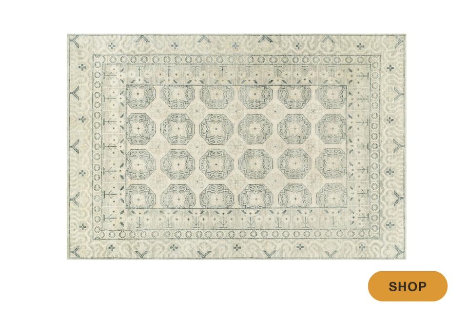 Soft pale green area rug with traditional Persian-style geometric and botanical ornaments