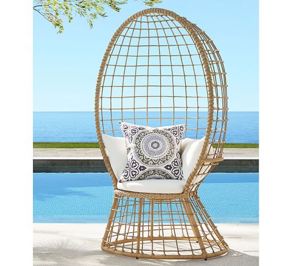 Luxury resort aesthetic, woven egg chair, poolside seaside setting