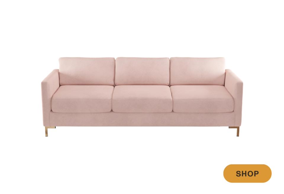 Contemporary blush pink three-seat sofa with clean lines and modern tapered legs against white background.