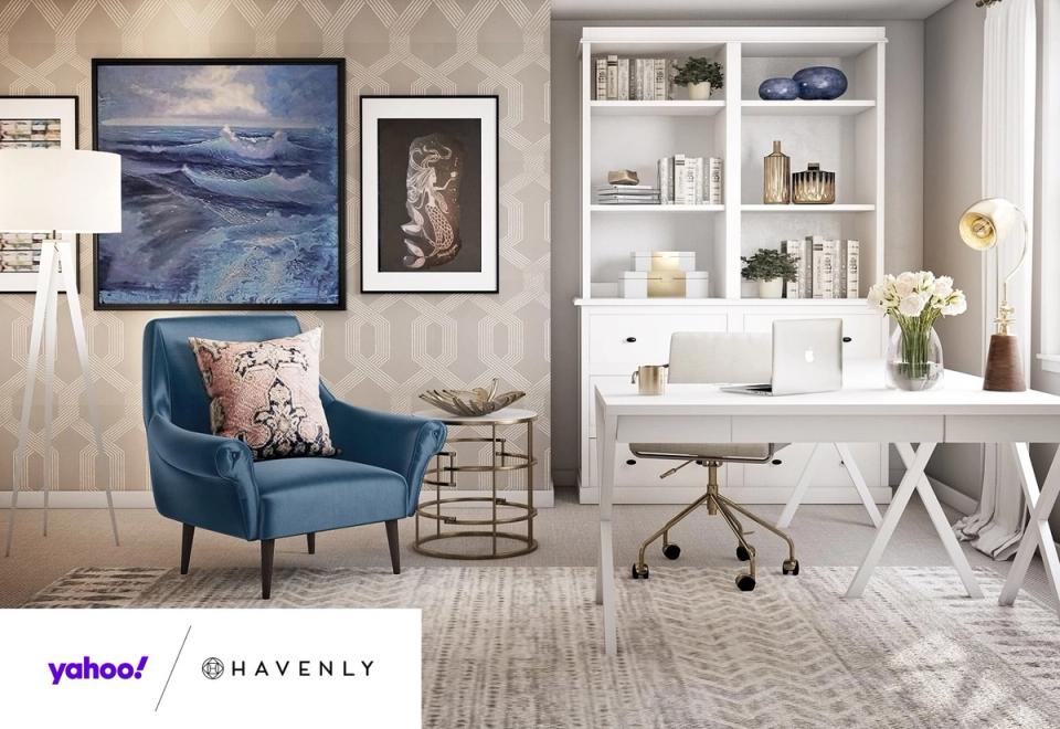Serene modern office with blue accent chair, white X-desk, and coastal-inspired artwork in neutral palette