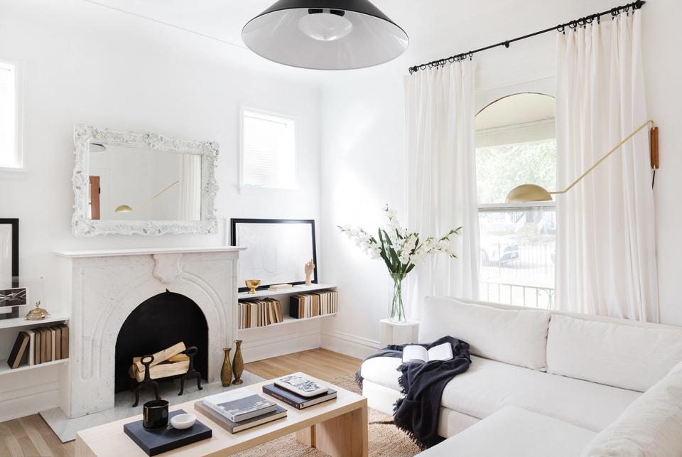 Scandinavian-inspired minimalist space with black wood-burning stove and clean white walls