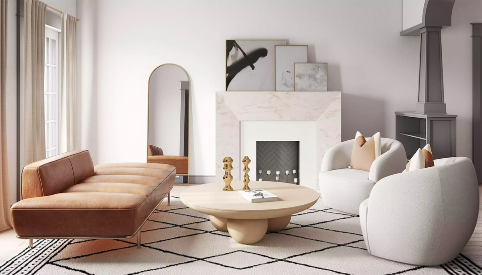 Modern living room with light gray walls, cognac leather chaise, and sculptural white seating creating a calm, contemporary aesthetic.