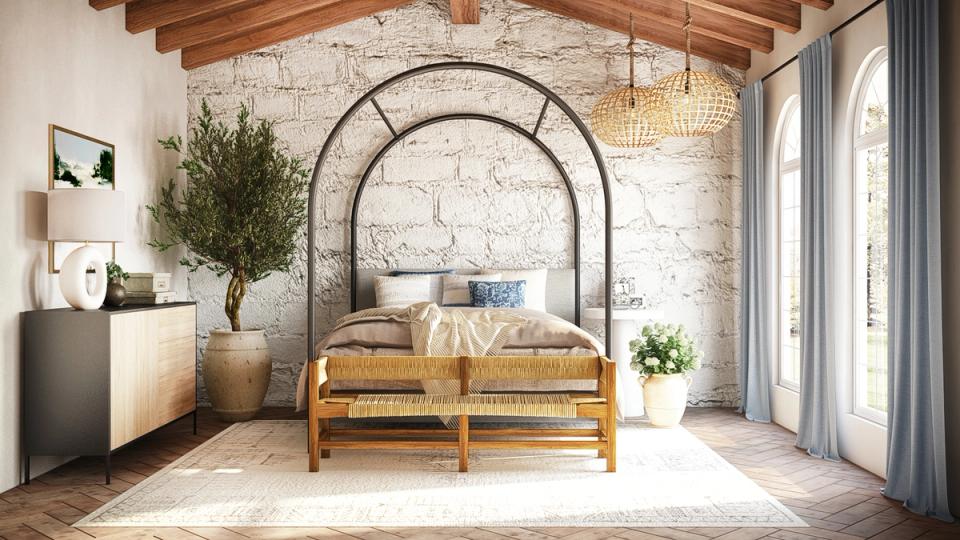 Rustic-industrial bedroom with arched metal bed frame, exposed wooden beams, and warm cream tones