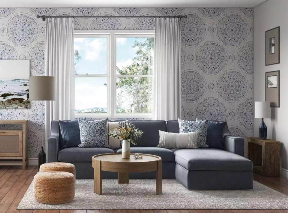 Jewel-toned traditional room in deep teal with built-in shelving, fireplace focal point, blush velvet seating, and warm layered styling.