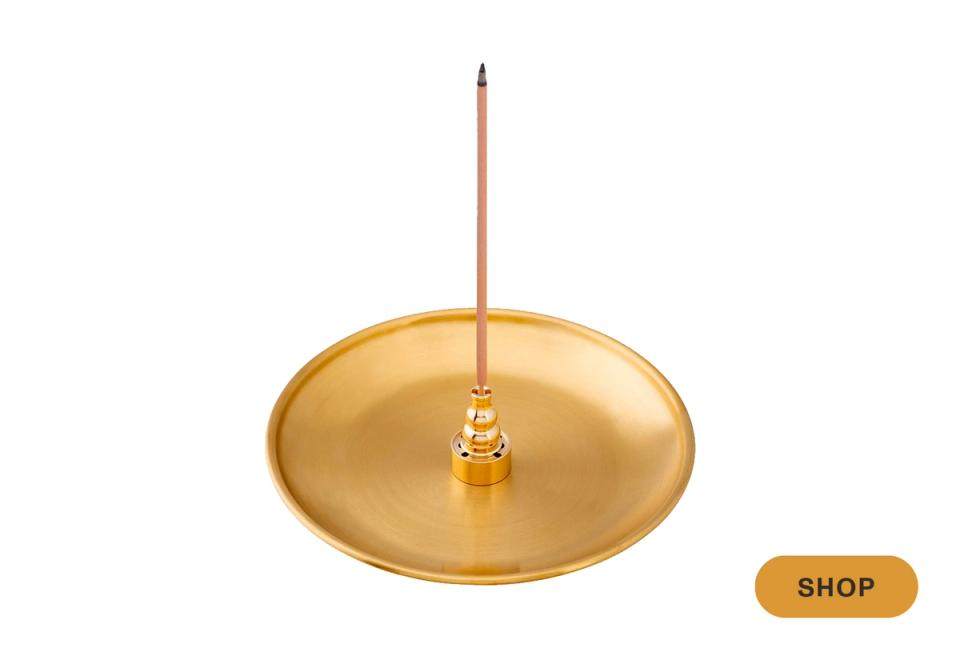 Minimalist brass pendant light with warm metallic finish and clean lines