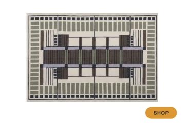 Modern geometric area rug in charcoal and cream with bold linear Art Deco-inspired motifs