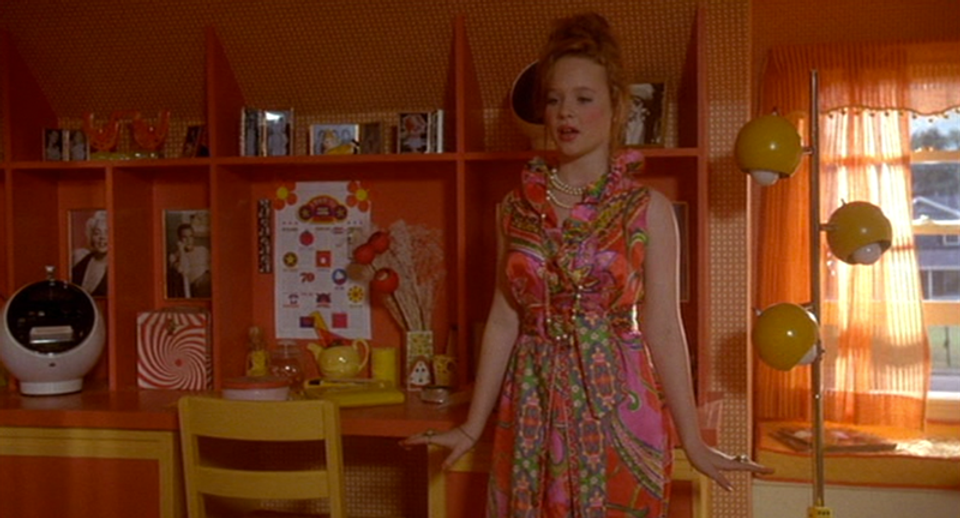 Bright retro kitchen in warm oranges with geometric patterns and mid-century charm