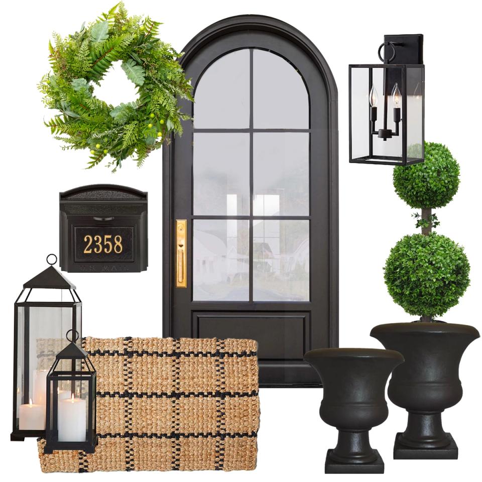 Modern farmhouse porch with black arched door, green wreath, topiary, and natural woven textures