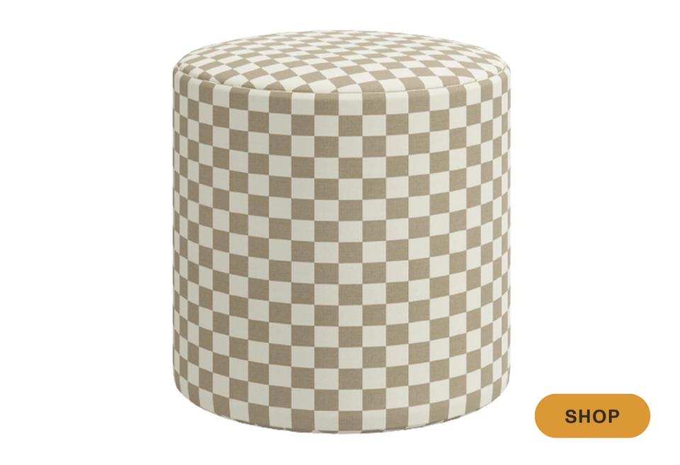 Upholstered cylindrical ottoman in cream and taupe checkerboard pattern