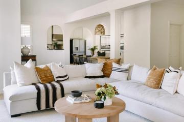 Contemporary living room with cream sectional, natural wood table, and organic modern aesthetic throughout