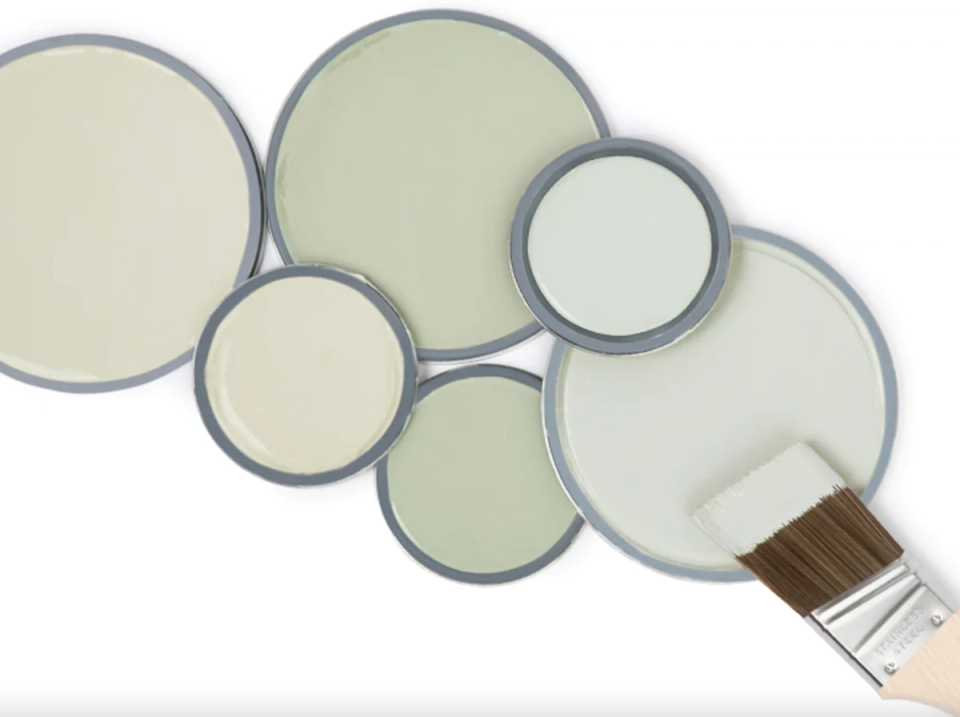 Soft, muted paint color palette samples in cream, sage, and greige tones with natural finish
