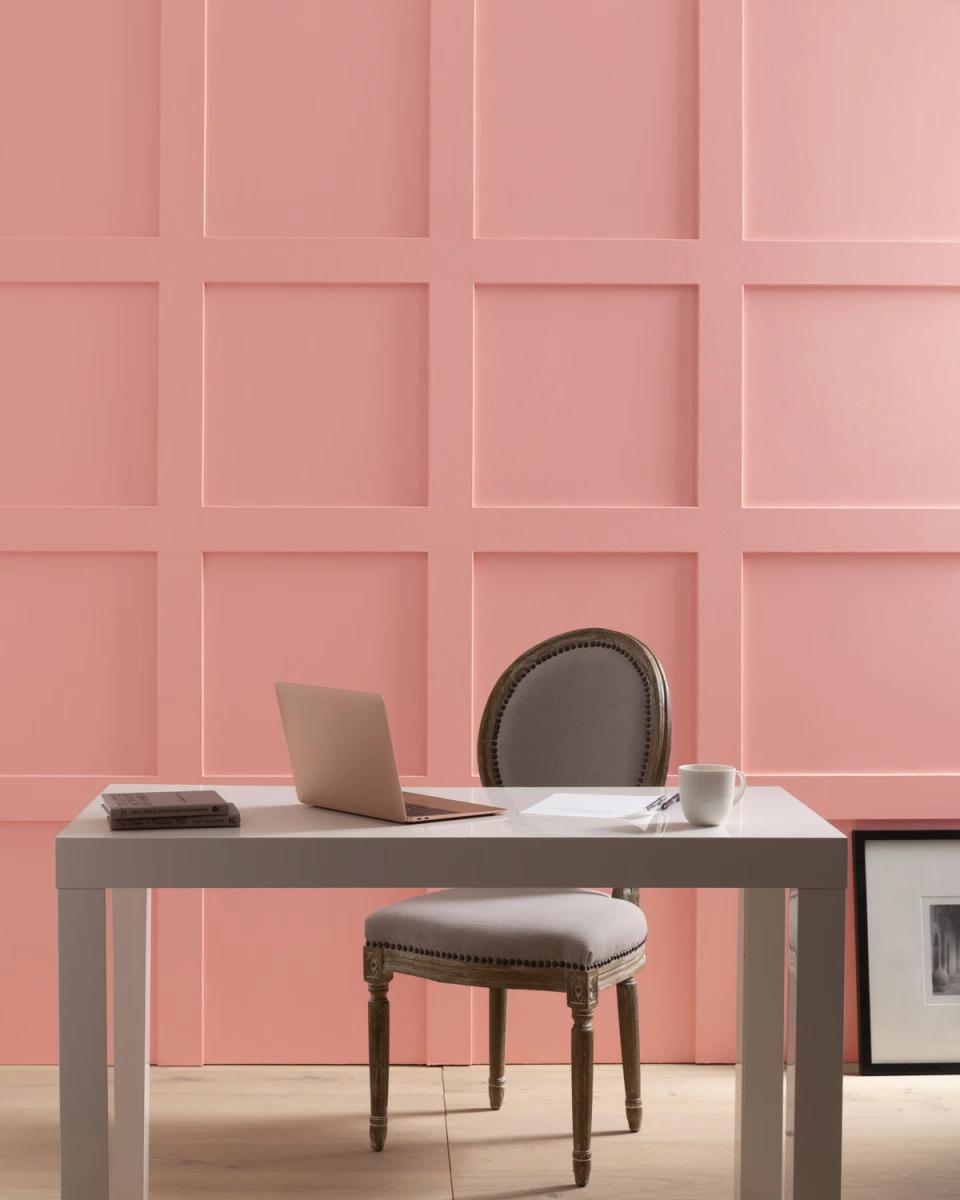 Contemporary office with soft pink shiplap wall paneling, gray desk, and clean Scandinavian-inspired workspace design