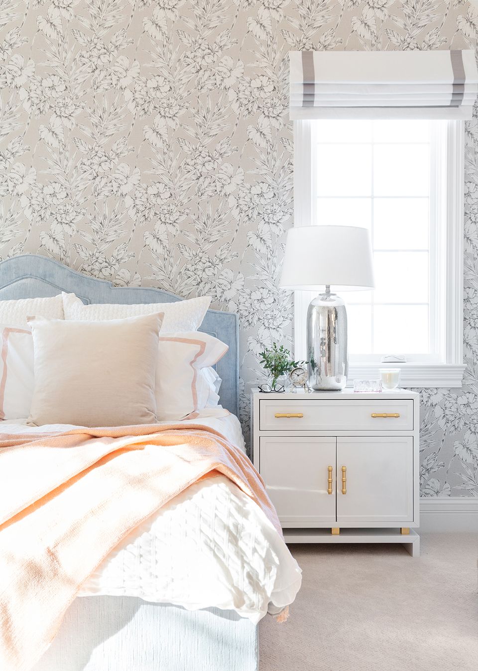Serene bedroom with soft palette, wallpaper accent, and gold hardware details