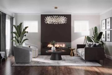 Modern minimalist living room with dark feature wall, fireplace, sculptural lighting, and lush greenery against soft gray and white palette.