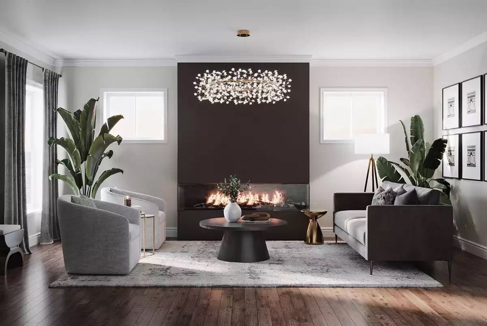 Modern minimalist living room with dark feature wall, fireplace, sculptural lighting, and lush greenery against soft gray and white palette.