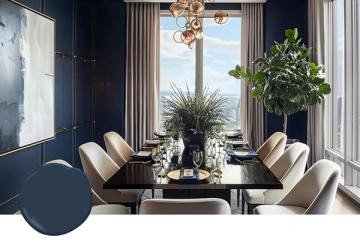 Sophisticated navy dining room with floor-to-ceiling windows, neutral upholstered chairs, and tropical greenery creating an elegant, light-filled retreat
