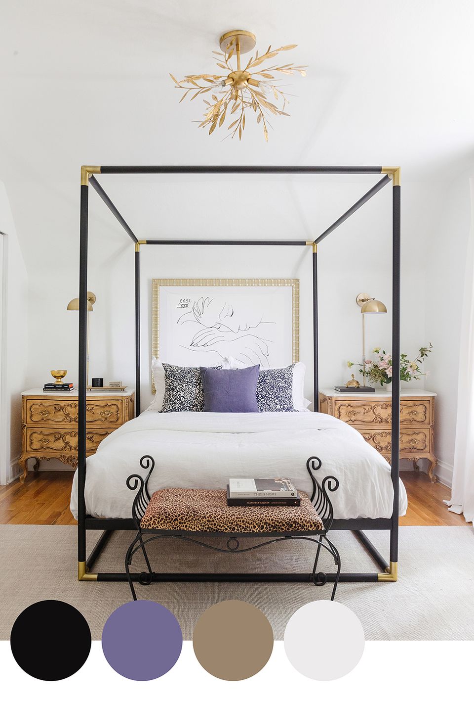 Eclectic bedroom blending mid-century modern elegance with jewel-tone purple accents, natural wood, and black metal canopy frame for dramatic sophistication.
