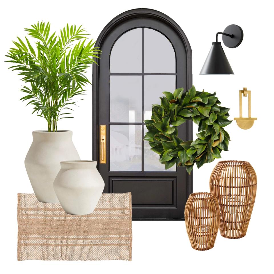 Coastal modern entry with black arched door, ivory ceramics, green wreath, and natural woven basket accents