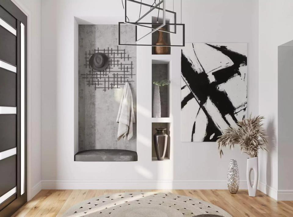 Modern minimalist entryway with geometric pendant lighting, abstract black artwork, and natural wood flooring.