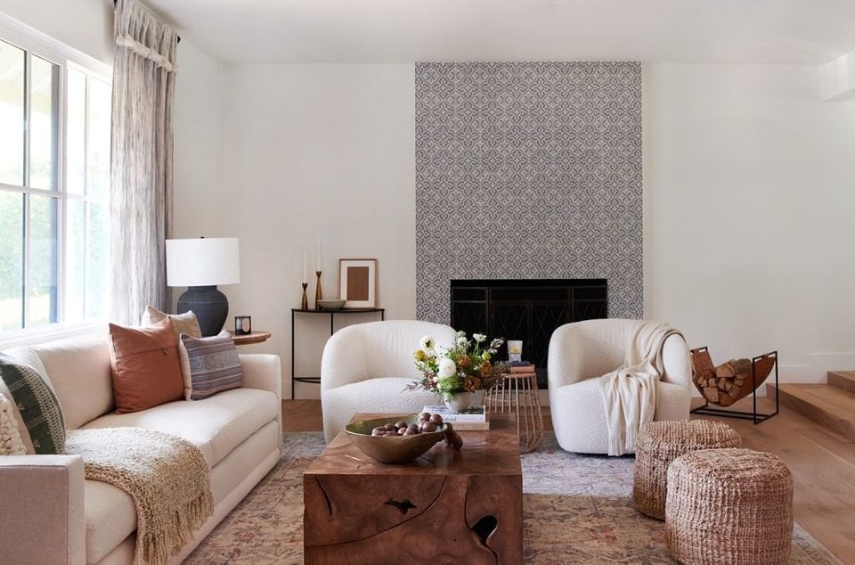 Warm neutral living room with cream sofa, woven accents, and soft terracotta pillows