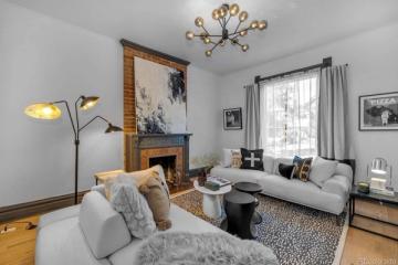 Scandinavian living room with warm wood accents, soft gray upholstery, and brass lighting creating a bright, airy minimalist aesthetic