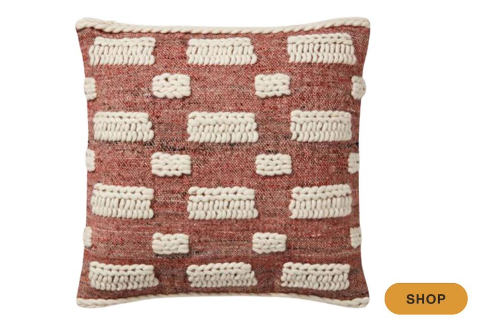 Rust and cream geometric patterned pillow with textured checkerboard design