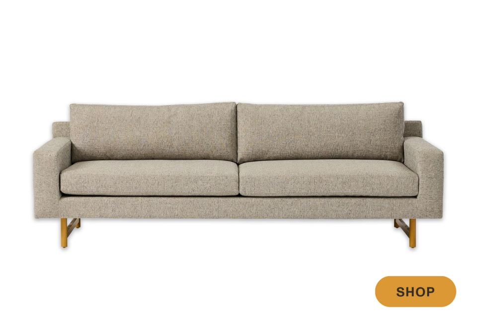 Mid-century modern beige sofa with tapered wood legs and clean profile