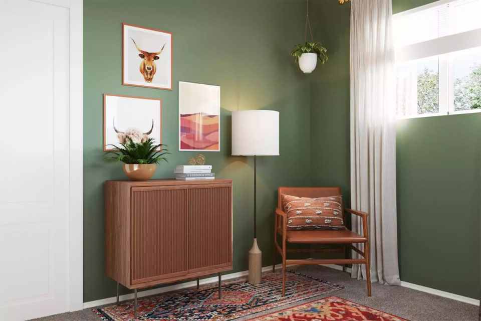 Botanical-inspired entryway with sage green walls, terracotta cabinet, and pendant lighting