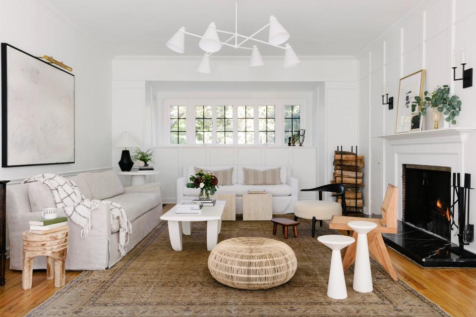 Scandinavian-inspired living room with clean white walls, natural wood accents, and cozy neutral furnishings creating a serene, balanced atmosphere