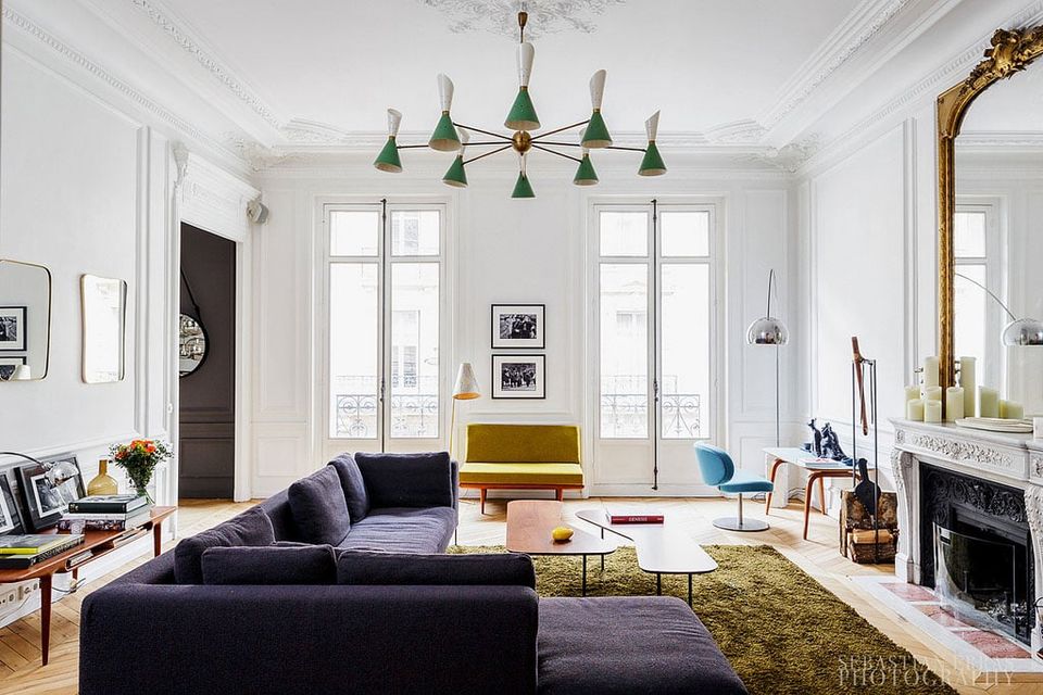 Modern living room with sculptural green pendant lights, purple sofa, and Parisian-inspired elegance