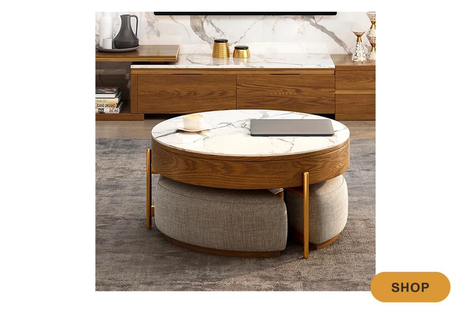 Contemporary round coffee table combining wood top, marble inlay, and upholstered base