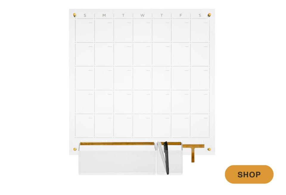 Clean white monthly calendar with brass hardware and minimal accents