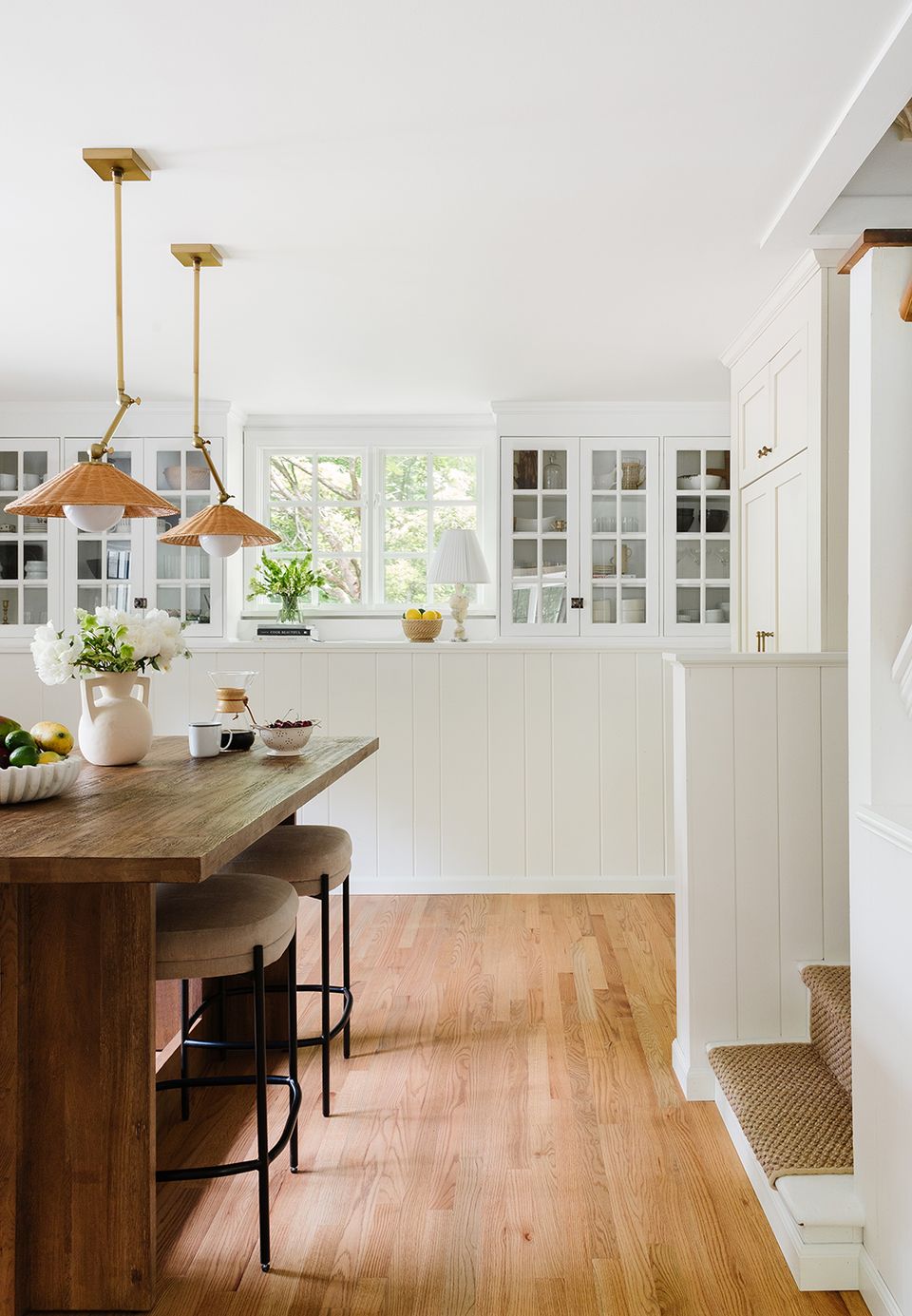 Light-filled modern farmhouse kitchen with cream cabinetry and natural wood flooring