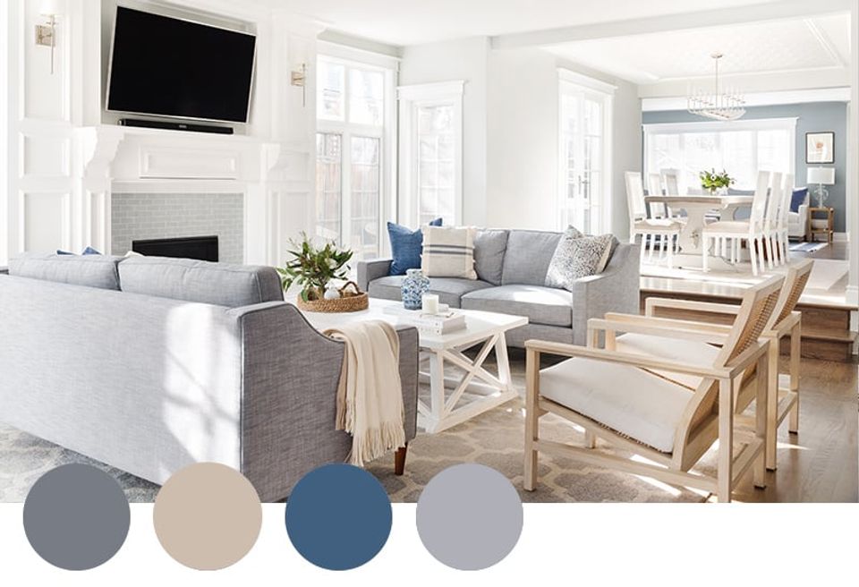 Bright coastal-inspired living room with navy and beige palette, natural wood elements, and white fireplace for airy, timeless design.