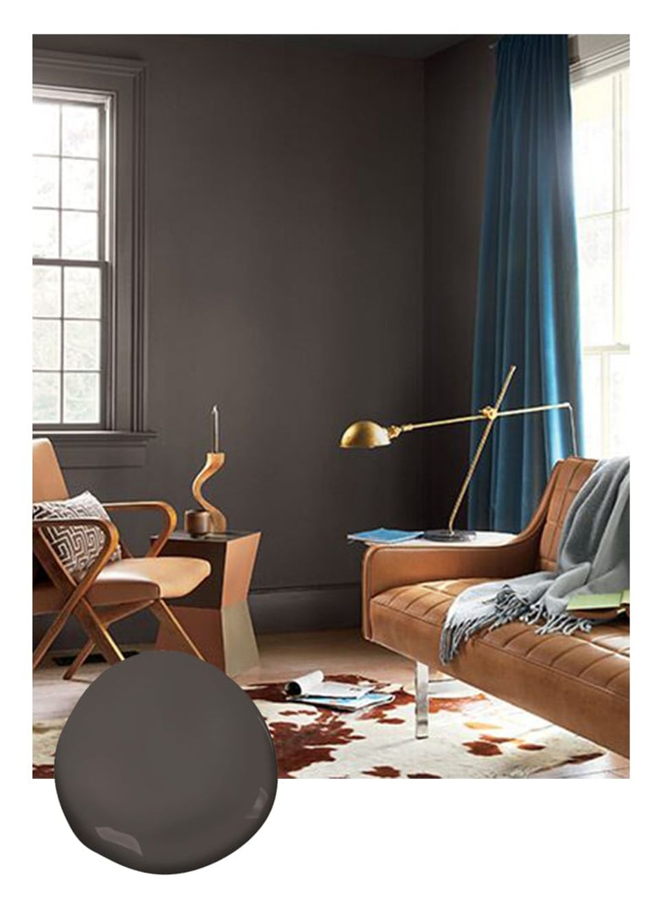 Modern mid-century living room with charcoal walls, cognac leather seating, and teal drapes creating warm, contemporary contrast