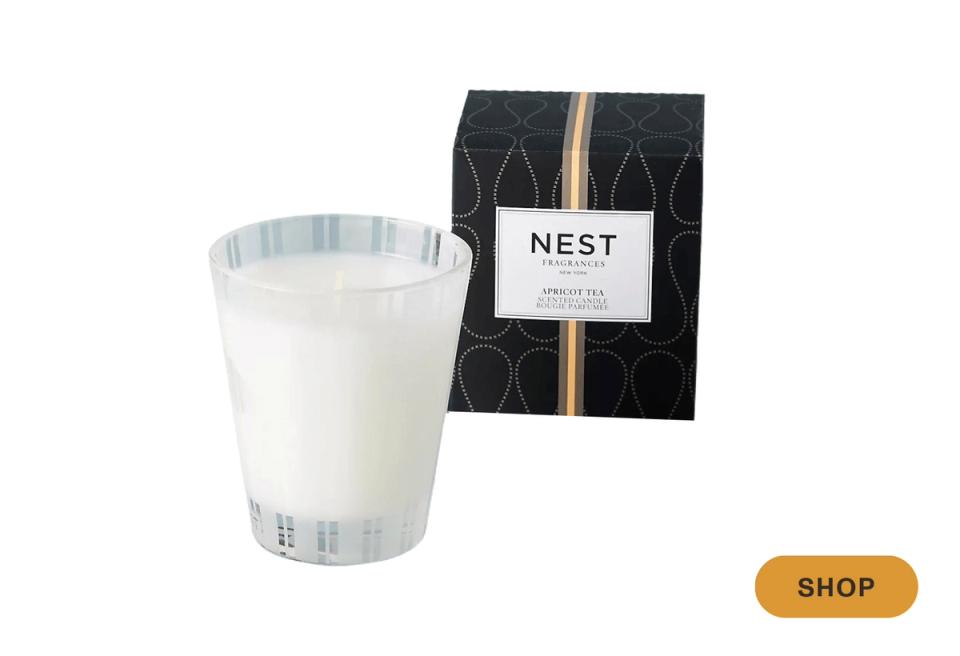 Modern scented candle with black geometric packaging and white vessel in contemporary style