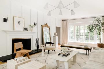 Serene Scandinavian living room with white fireplace, light wood accents, and neutral tones