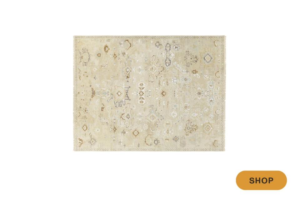 Neutral traditional area rug with subtle ornate pattern in cream and taupe tones