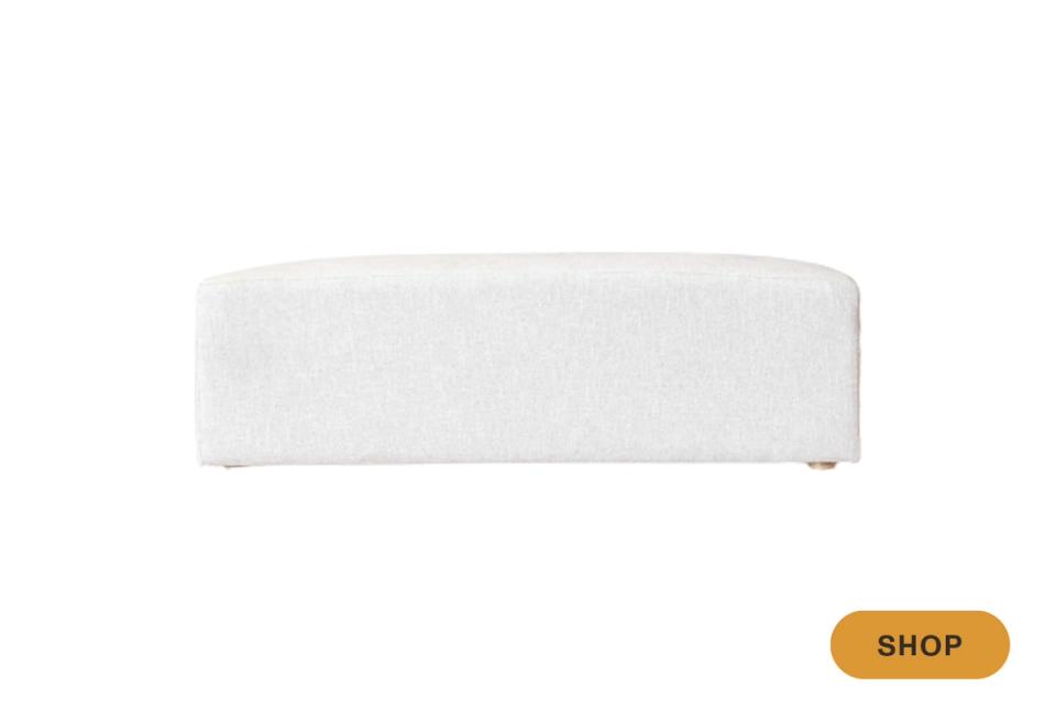 Soft white curved bench with organic modern silhouette and understated contemporary elegance