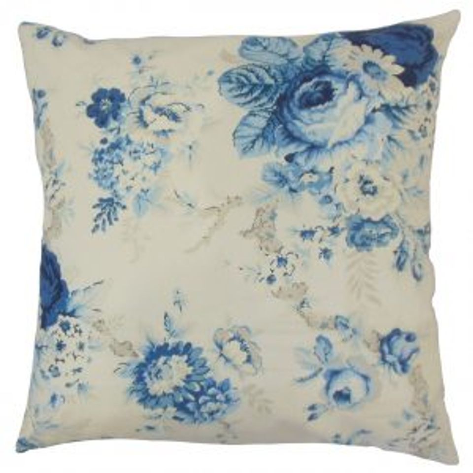 Cream pillow with vintage blue floral print evoking timeless seaside charm