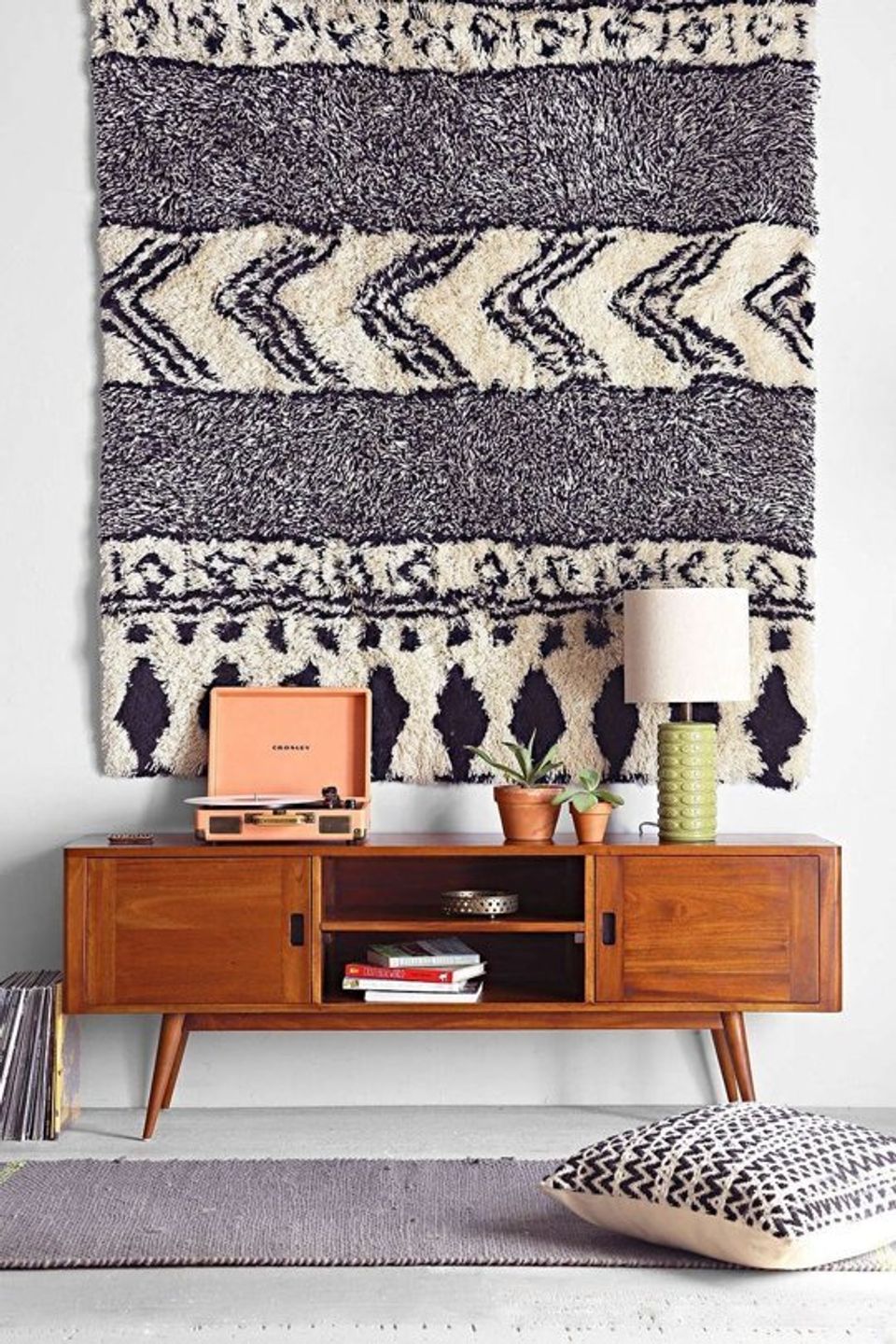 Mid-century modern console with geometric patterned wall hanging in navy and cream tones