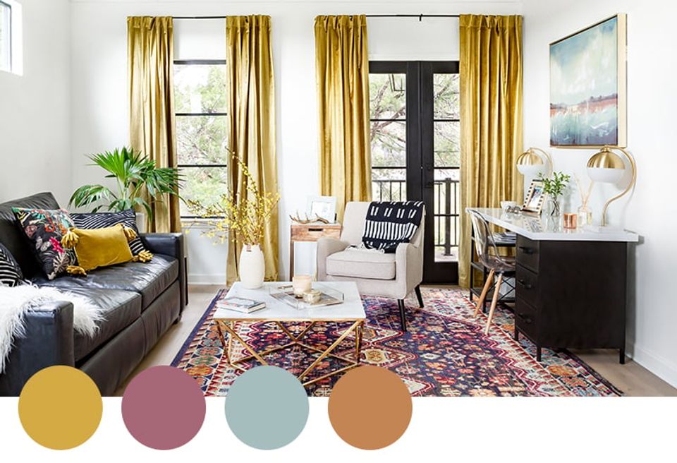 Jewel-toned eclectic living room with gold curtains, burgundy accents, and layered textures creating a sophisticated, moody atmosphere