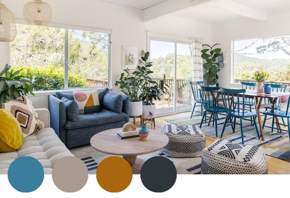 Bright mid-century modern living space combining teal, mustard gold, and navy with natural wood and abundant indoor plants.