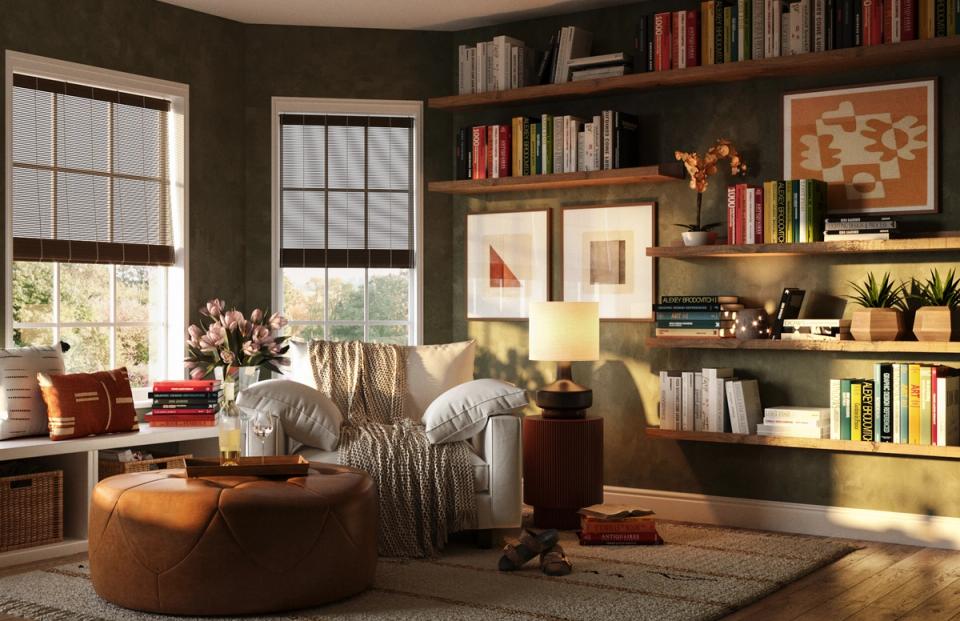 Warm, earthy reading room with olive walls, built-in shelving, leather ottoman, and natural light from large windows