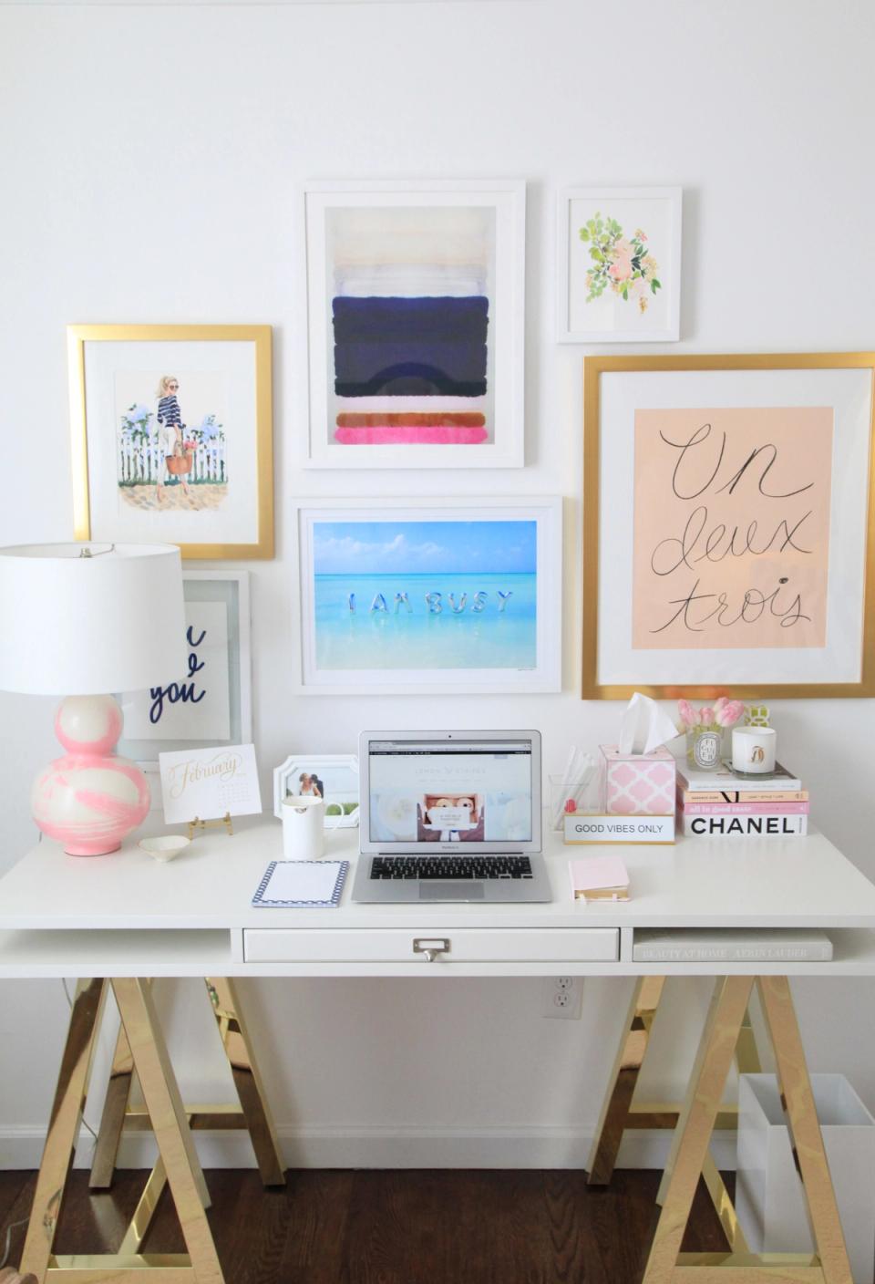 Preppy, gallery-wall desk setup with mixed frame styles, colorful accents, and organized workspace.