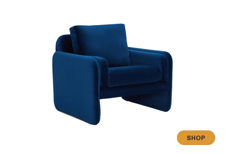 Rich jewel-tone blue velvet armchair with modern curved design