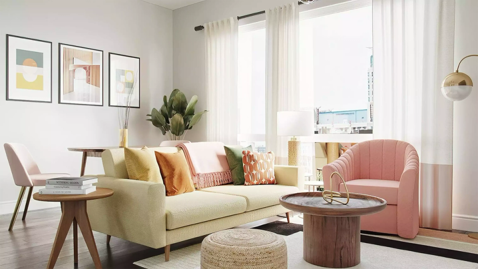 Bright living space with light gray walls, cream sofa, coral accents, and natural light creating a warm, inviting modern interior.